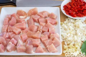 Trocear el pollo y picar cebolla y ajo